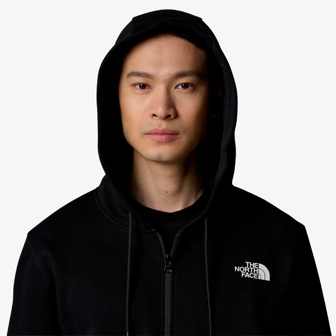 Homme portant un sweat à capuche The North Face Simple Dome, avec capuche et fermeture zippée intégrale.
