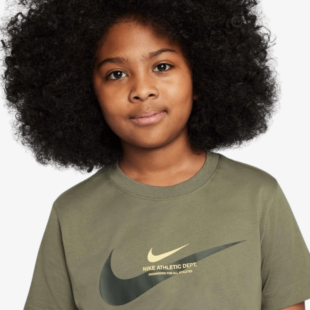 Nike Sportswear Graphic T-Shirts featuring a child wearing a comfortable olive green t-shirt with a logo.